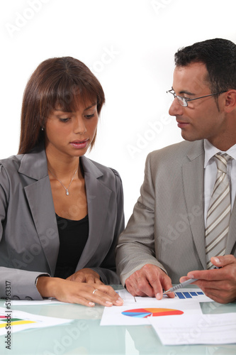Photo: Two businesspeople going over results Two businesspeople going over results