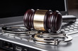 handcuffs and judge gavel on computer concept