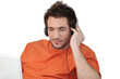 Man listening to his laptop via his headphones