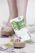 frauen füße mit schuhe und geld