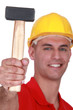 Manual worker proudly showing off hammer