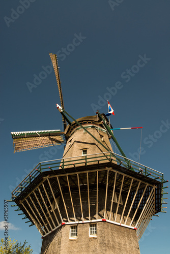 Photo: Amsterdam, The Netherlands. Typical Dutch Windmill on a sunny da Amsterdam, The Netherlands. Typical Dutch Windmill on a sunny da