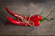 tied red chili peppers on old wooden table
