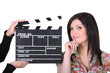 a woman posing near a movie clap