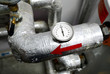 industrial thermometer on a water pipeline in a boiler room