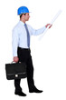 Architect with briefcase and plans