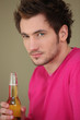 Young man with a bottle of lager