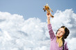 girl in helmet pilot playing with a toy airplane