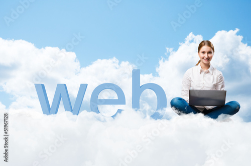 Photo: girl sitting cross-legged on the clouds girl sitting cross-legged on the clouds