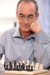 Photo: Old man playing chess Old man playing chess
