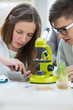 Photo: High School students. Girl and boy working together at biology c High School students. Girl and boy working together at biology c