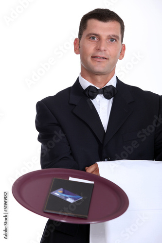 Photo: Waiter with the bill and a credit card Waiter with the bill and a credit card