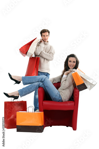 Photo: Woman sitting in a chair and surrounded by shopping bags Woman sitting in a chair and surrounded by shopping bags