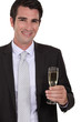 Photo: Confident businessman holdingvchampagne Confident businessman holdingvchampagne