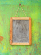 old blackboard hanging on painted wooden wall, free copy space