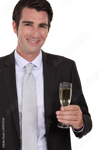 Photo: Confident businessman holdingvchampagne Confident businessman holdingvchampagne