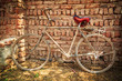 Photo: Dusty old bike at brick wall Dusty old bike at brick wall
