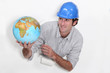 Photo: Construction worker holding a globe Construction worker holding a globe