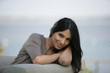 Photo: beautiful brunette sitting on the couch beautiful brunette sitting on the couch