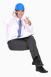 Thumbs up from a businessman in a hardhat