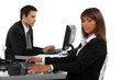 Two young business colleagues working hard