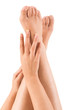 Beautiful hands on legs over white background