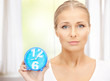 woman holding alarm clock