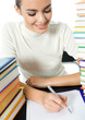 Photo: Writing woman with textbooks, isolated Writing woman with textbooks, isolated