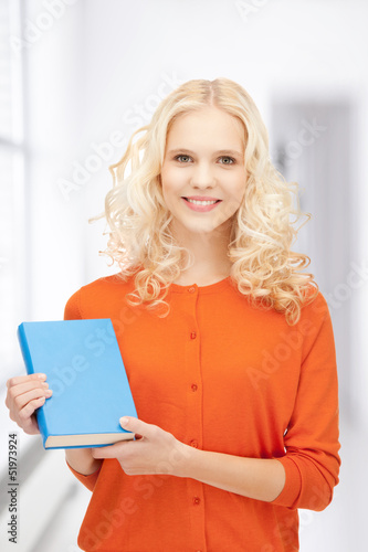 Photo: happy and smiling woman with book happy and smiling woman with book