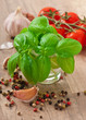 basil leaves, garlic and pepper on a wooden background