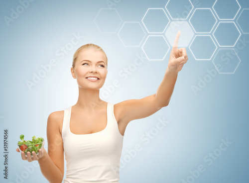 Photo: woman with salad and virtual screen woman with salad and virtual screen