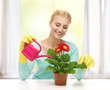 housewife with flower in pot and watering can