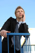 Young businessman using his phone outside