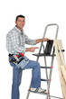 Photo: Builder with wood and a laptop Builder with wood and a laptop