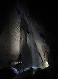 Hiker in a cave, Pissai waterfall, grotta Rio Martino, Italy
