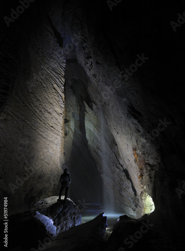 Photo: Hiker in a cave, Pissai waterfall, grotta Rio Martino, Italy Hiker in a cave, Pissai waterfall, grotta Rio Martino, Italy