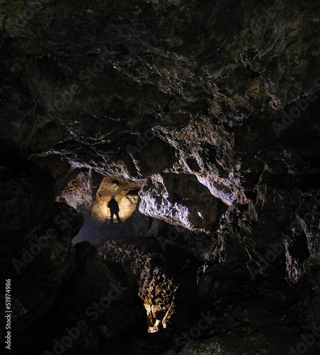 Photo: Caver in a cave, Pugnetto, Mezzenile, Piedmont, Italy Caver in a cave, Pugnetto, Mezzenile, Piedmont, Italy