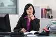 Brunette office worker thinking