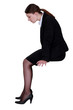 businesswoman sitting in profile with legs dangling