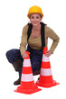 Woman kneeling by traffic cones