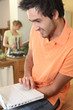 woman cooking and man with computer