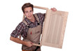 Carpenter holding cupboard door