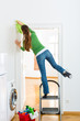 Photo: Woman at the spring cleaning working dangerously Woman at the spring cleaning working dangerously