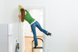 Woman at the spring cleaning working dangerously