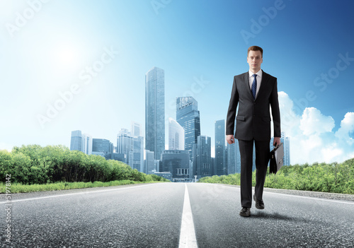 Photo: business man walking on the road business man walking on the road