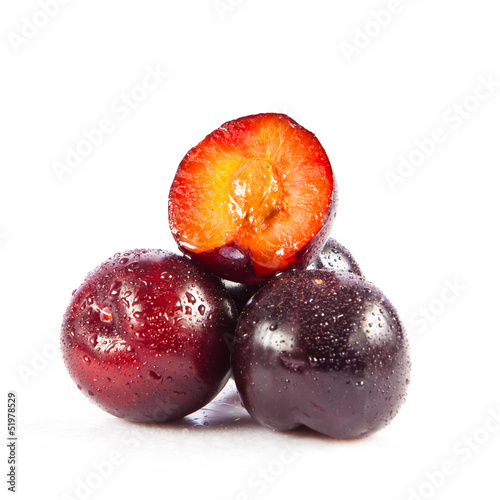 Photo: Red plum fruit isolated on white background. Fresh ripe washed Red plum fruit isolated on white background. Fresh ripe washed
