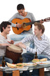 Photo: Three friends playing musical instruments Three friends playing musical instruments