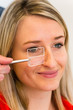 Optometry concept - pretty young woman having her eyes examined