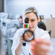 Photo: Pretty young optometrist at work Pretty young optometrist at work