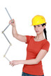 Construction worker holding a ruler